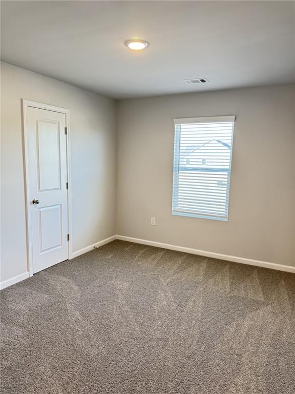 11075 Suria Drive Covington, GA 30014 - Photo 7 of 12 an empty room with a window
