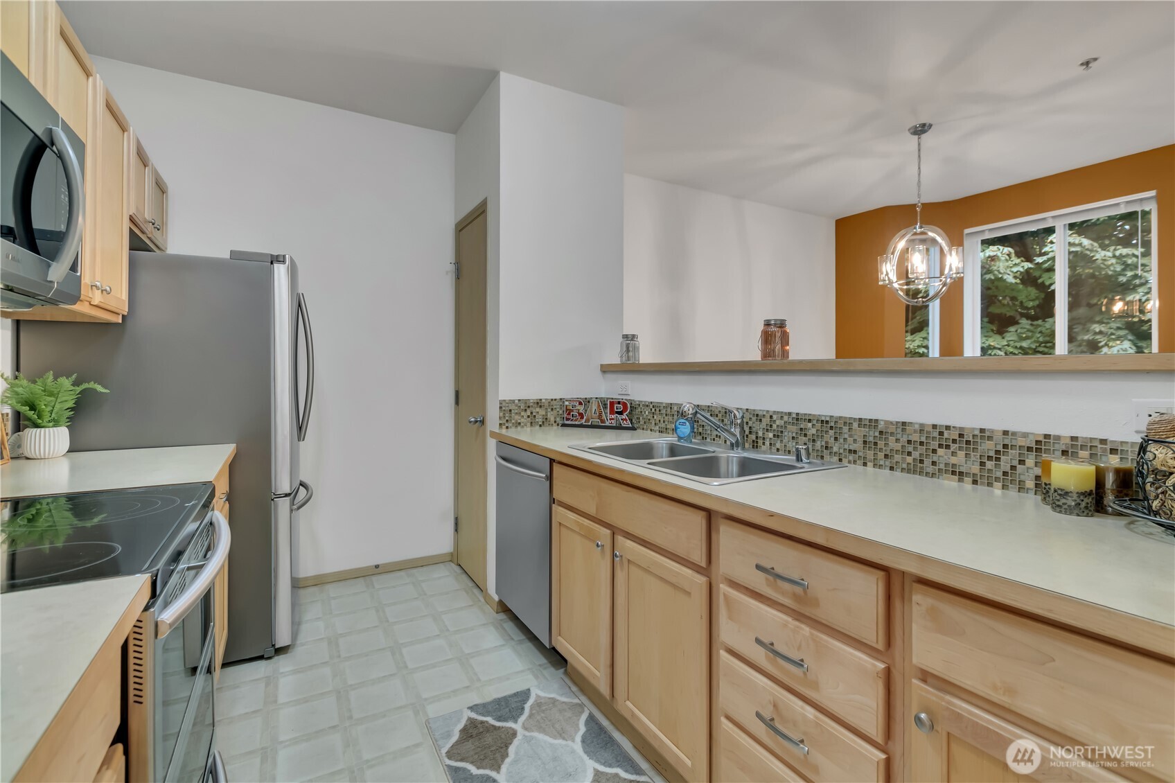 3012 Southeast 8th Place, Unit 1117 Renton, WA 98058 - Photo 12 of 28 a kitchen with stainless steel appliances granite countertop a sink stove and refrigerator