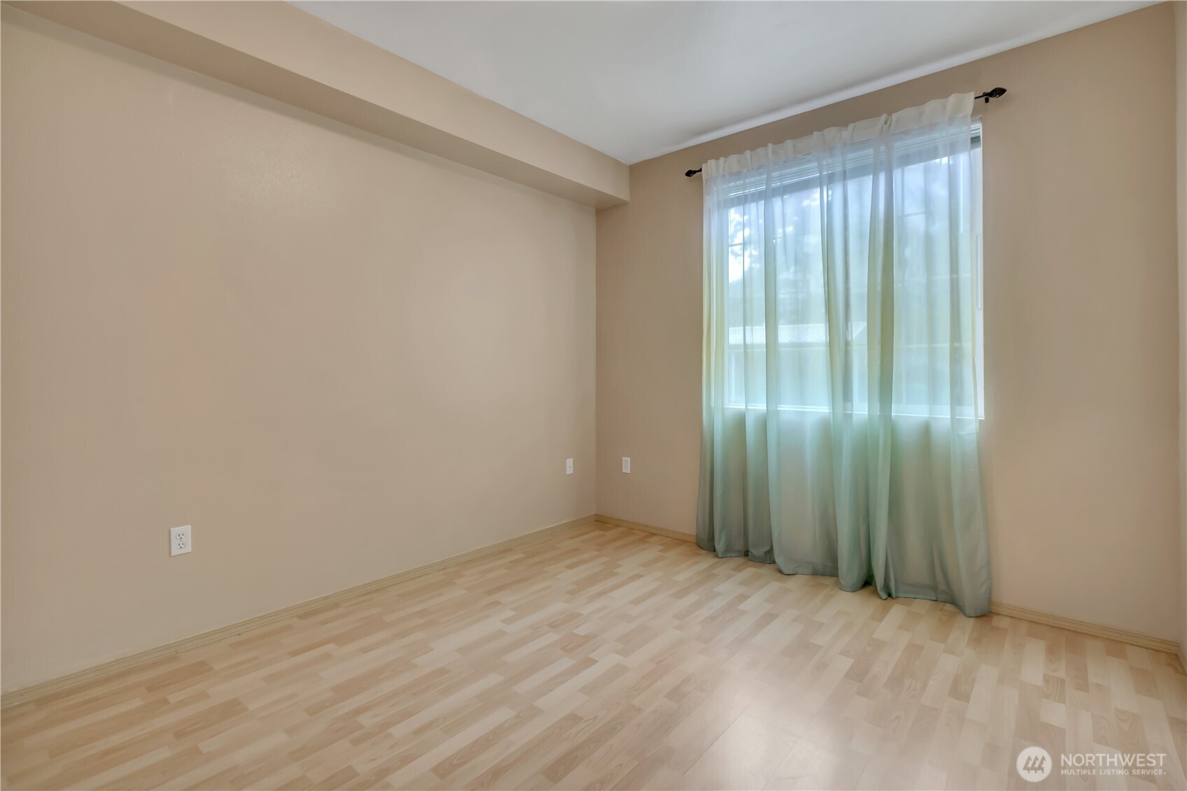 3012 Southeast 8th Place, Unit 1117 Renton, WA 98058 - Photo 16 of 28 a view of an empty room with wooden floor