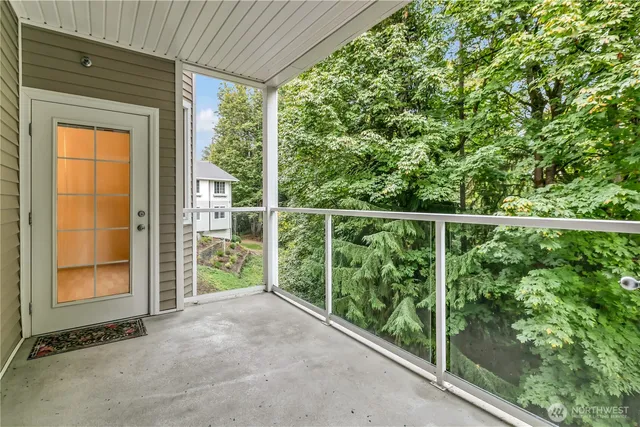 a view of a porch with a floor to ceiling window and tree