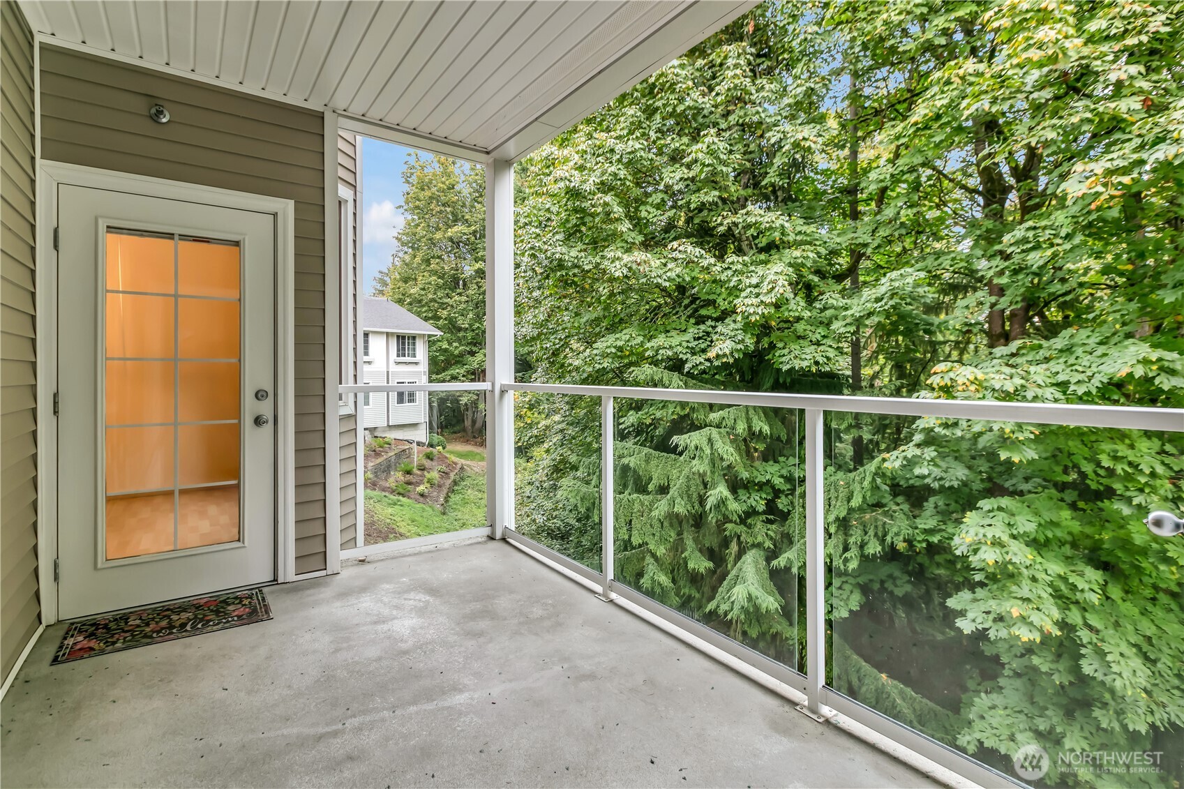 3012 Southeast 8th Place, Unit 1117 Renton, WA 98058 - Photo 20 of 28 a view of a porch with a floor to ceiling window and tree