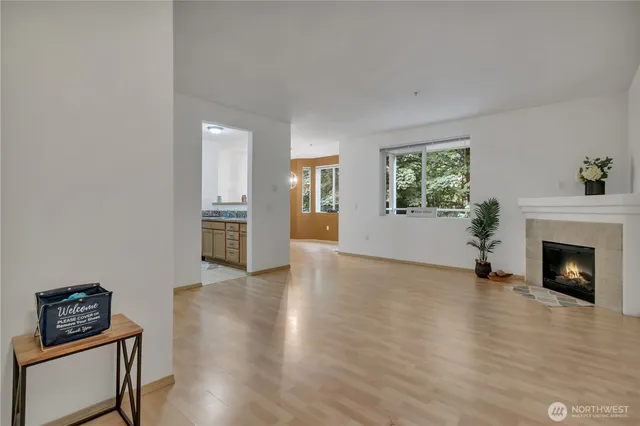 a view of an empty room with window and fire place