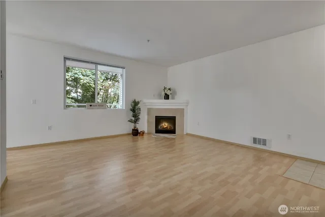 wooden floor fireplace and natural light in room