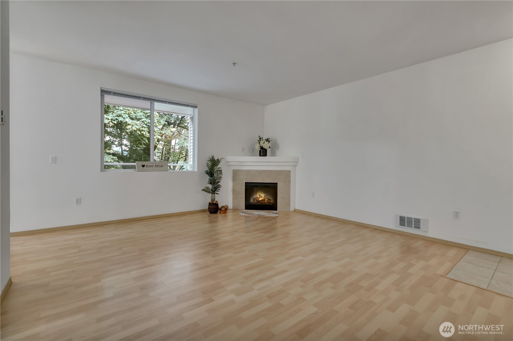 3012 Southeast 8th Place, Unit 1117 Renton, WA 98058 - Photo 4 of 28 wooden floor fireplace and natural light in room
