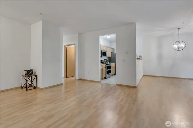 an empty room with wooden floor and closet