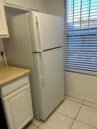 en empty room with wooden floor fan and window