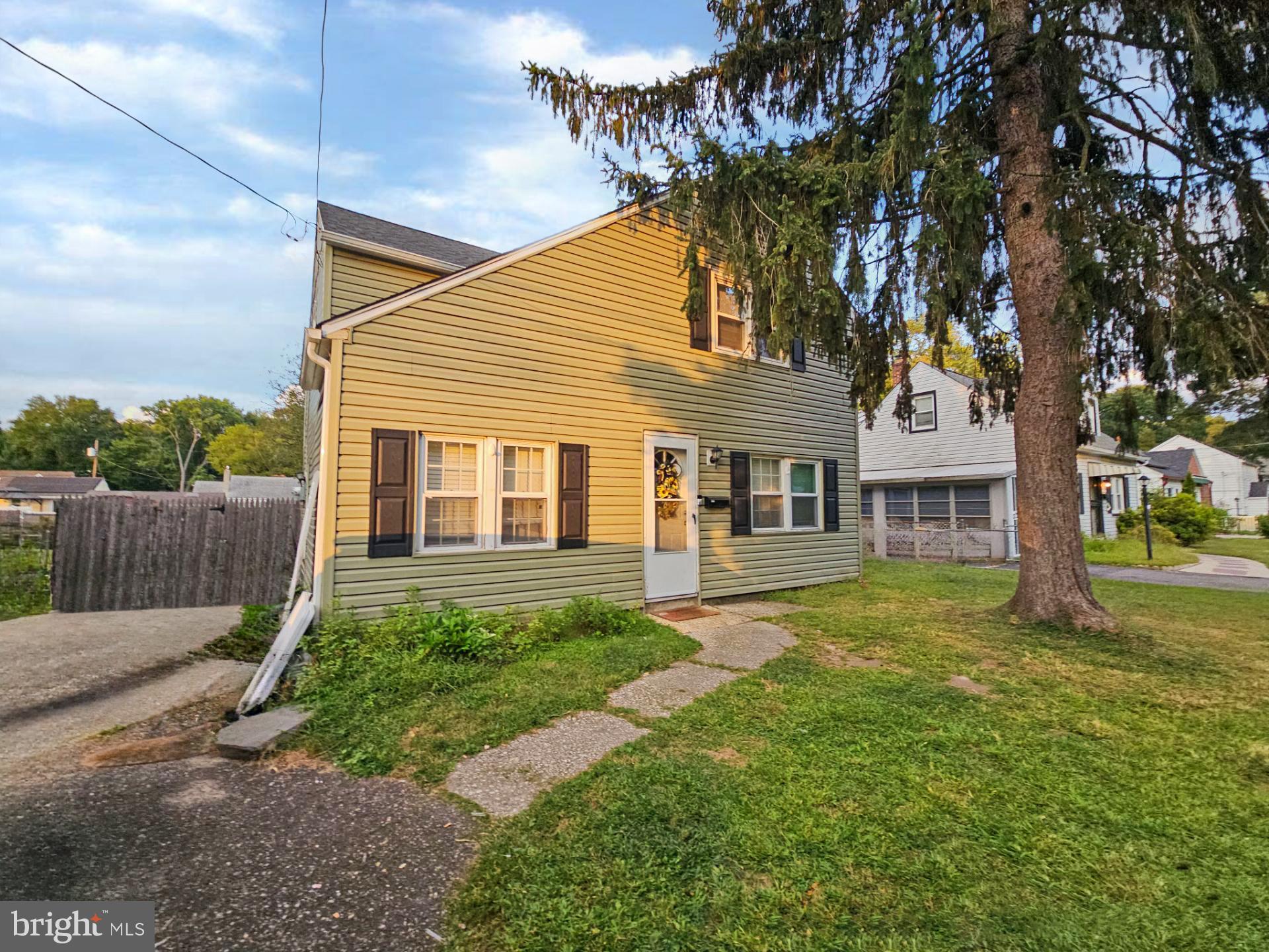 39 Maplewood Avenue Carneys Point, NJ 08069 - Photo 1 of 9 a front view of a house with a yard and trees