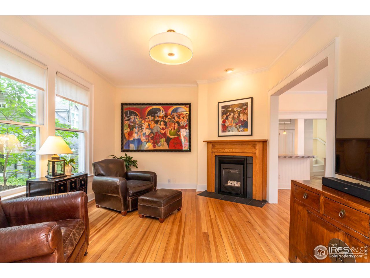 1063 Mapleton Avenue Boulder, CO 80304 - Photo 11 of 38 a living room with furniture a fireplace and a flat screen tv