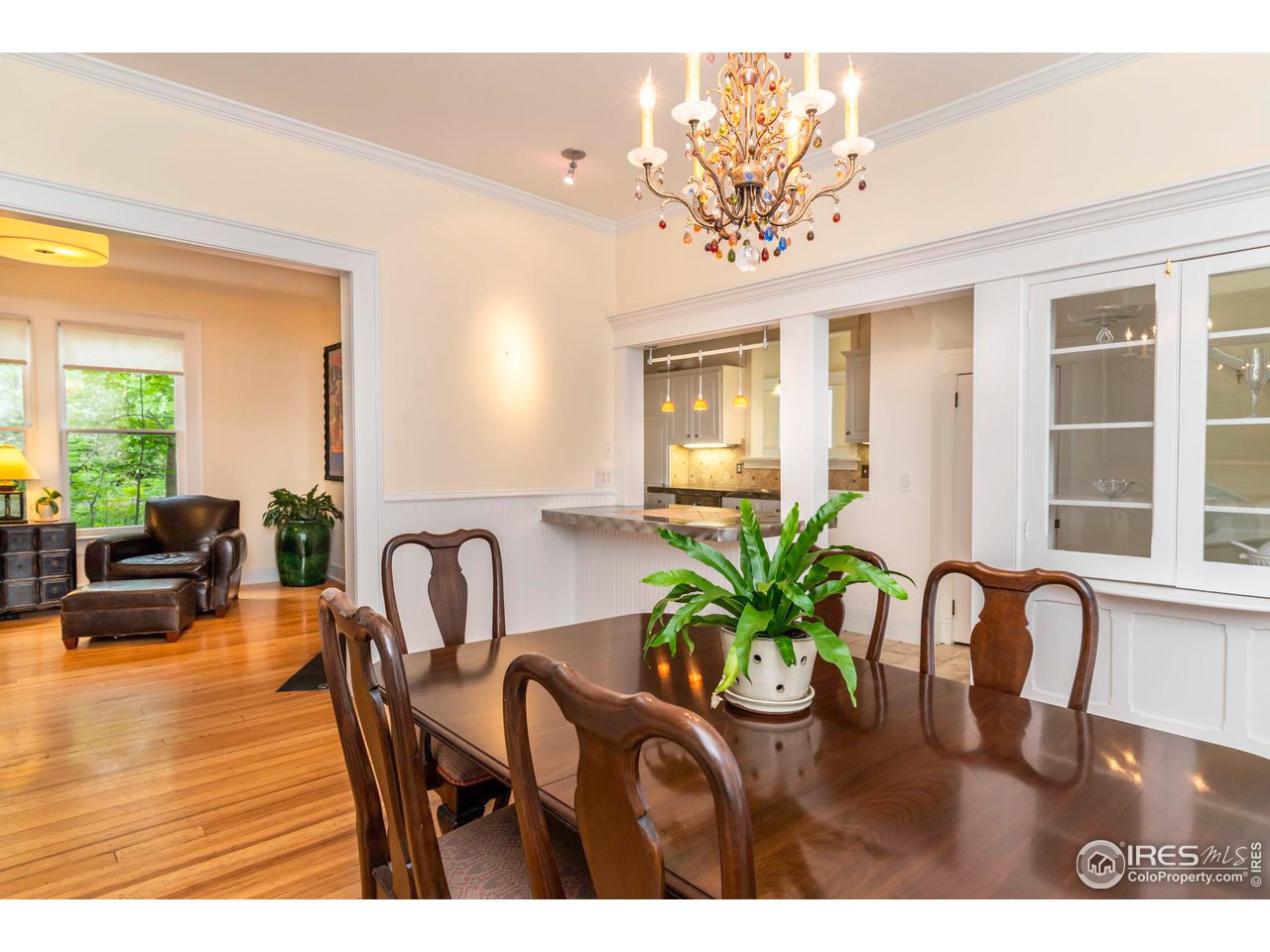 1063 Mapleton Avenue Boulder, CO 80304 - Photo 14 of 38 a dining room with furniture potted plants and wooden floor