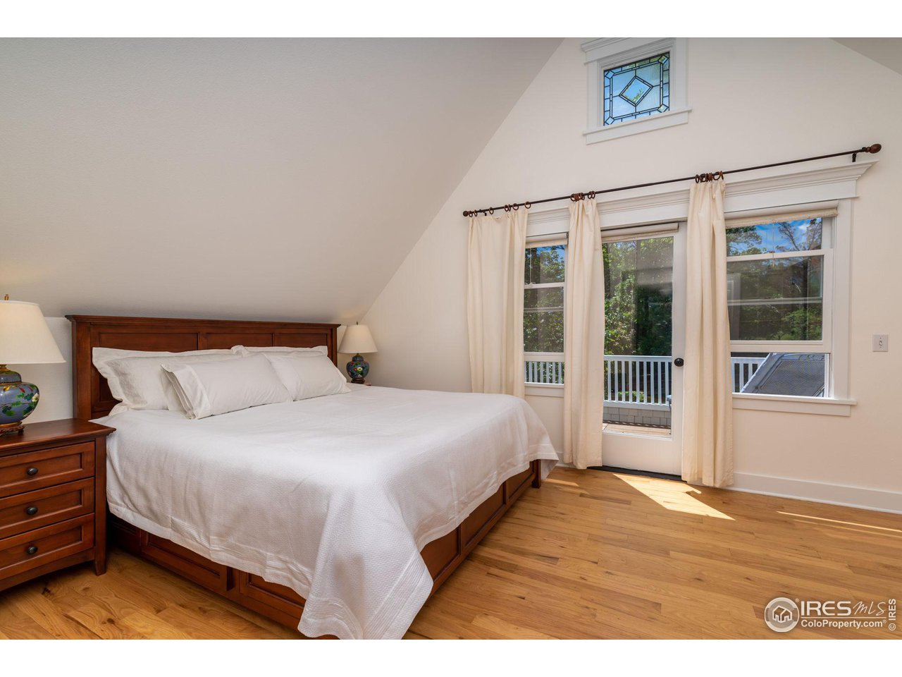 1063 Mapleton Avenue Boulder, CO 80304 - Photo 21 of 38 a bedroom with a large bed and a large window