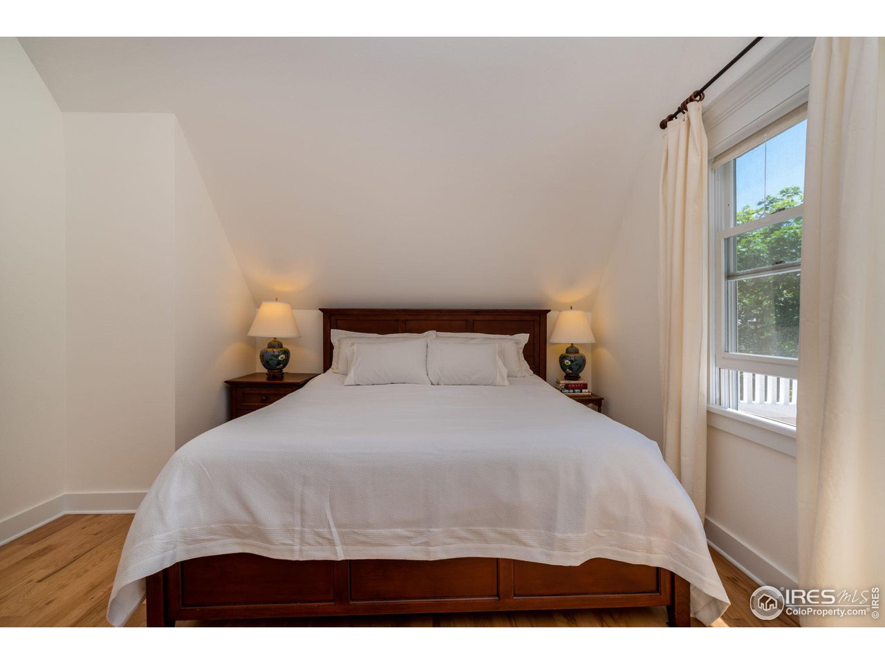 1063 Mapleton Avenue Boulder, CO 80304 - Photo 22 of 38 a bedroom with a bed and window