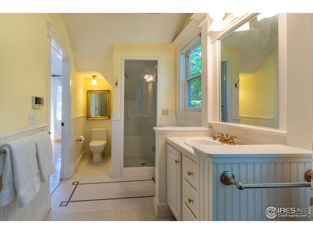 1063 Mapleton Avenue Boulder, CO 80304 - Photo 24 of 38 a bathroom with a granite countertop sink a mirror and a shower