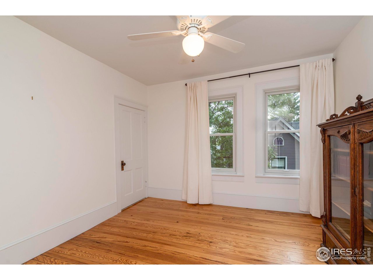 1063 Mapleton Avenue Boulder, CO 80304 - Photo 27 of 38 a view of an empty room with window chandelier fan and fire place
