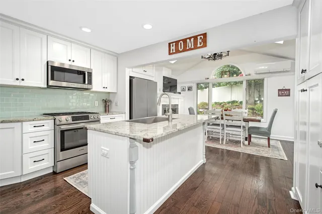 a kitchen with stainless steel appliances granite countertop a stove and a refrigerator
