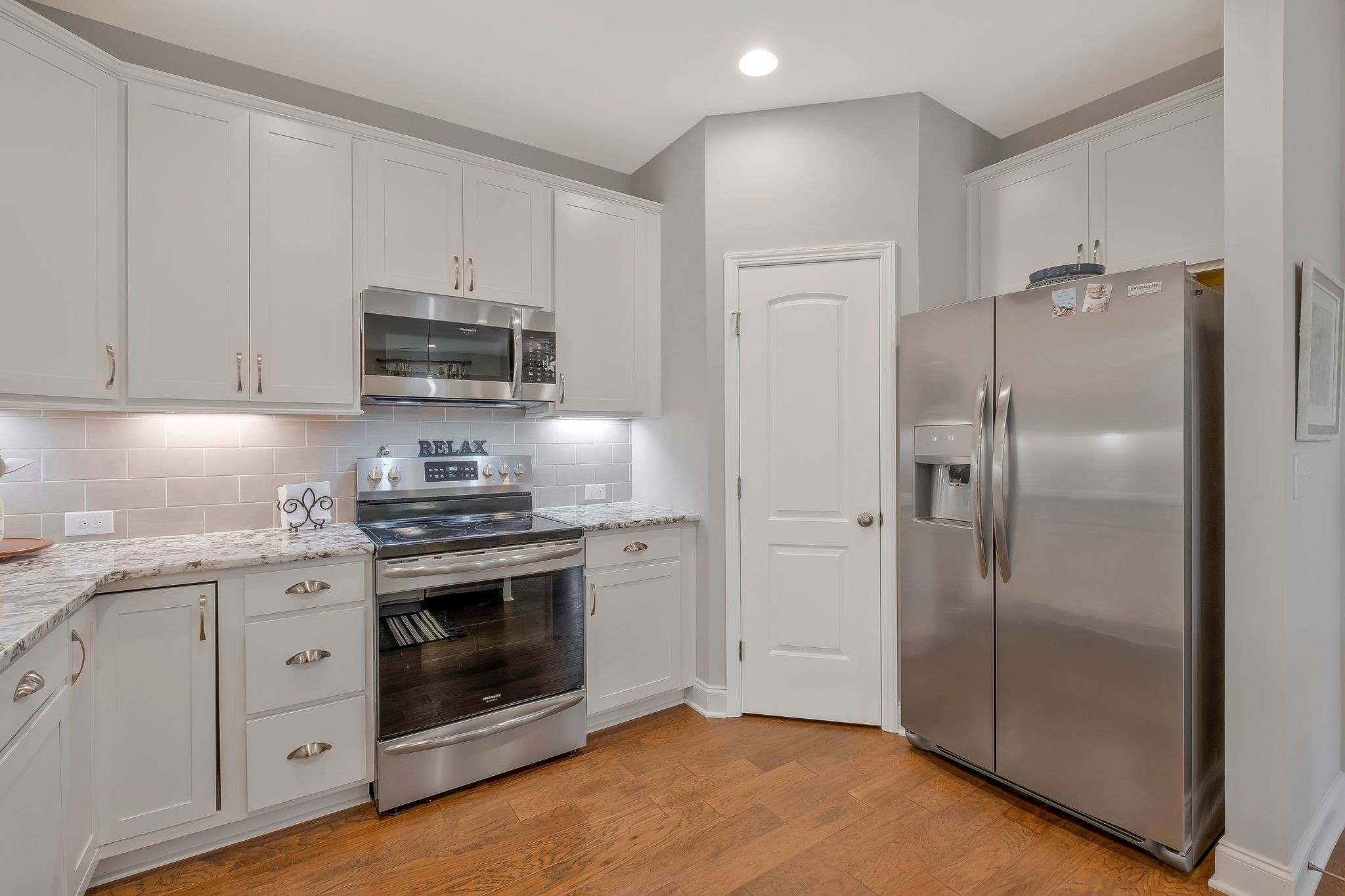 100 Jane Crossing Mount Juliet, TN 37122 - Photo 13 of 33 a kitchen with stainless steel appliances granite countertop a stove a refrigerator and a microwave