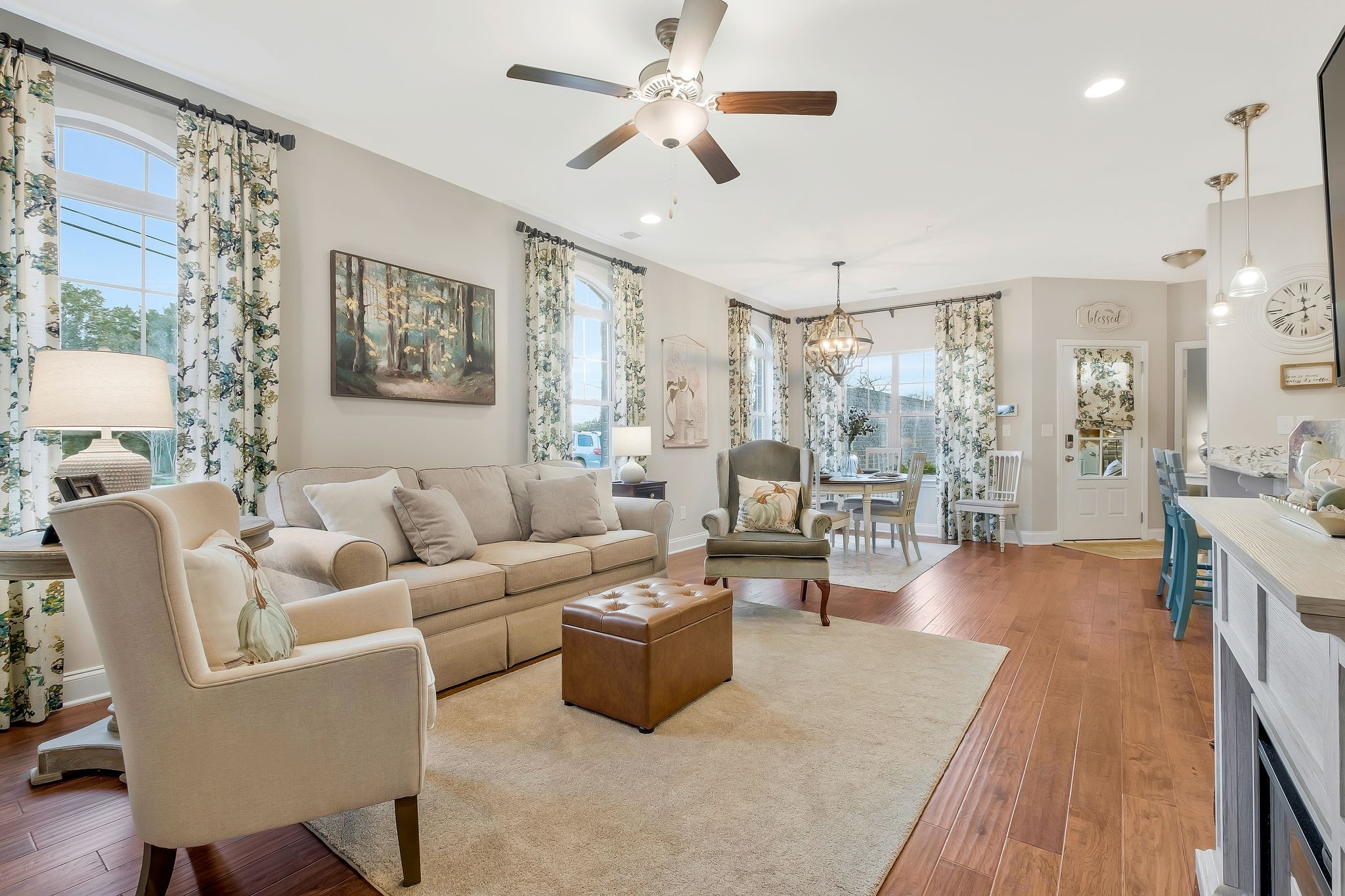 100 Jane Crossing Mount Juliet, TN 37122 - Photo 7 of 33 a living room with furniture a chandelier fan and a view of kitchen