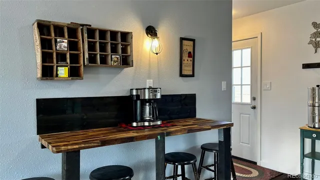 a table with chairs and a window