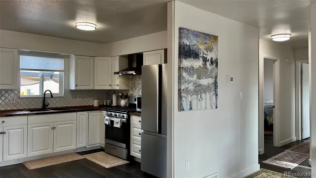 a kitchen with a refrigerator and a sink