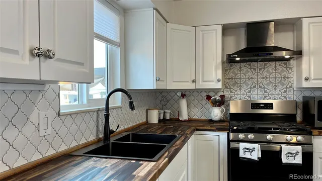 a kitchen with a sink and a stove top oven