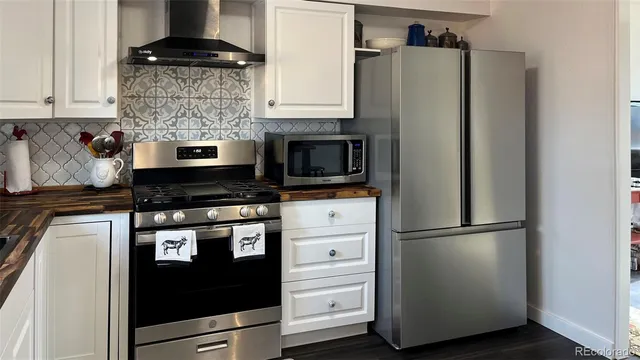 a kitchen with appliances and cabinets
