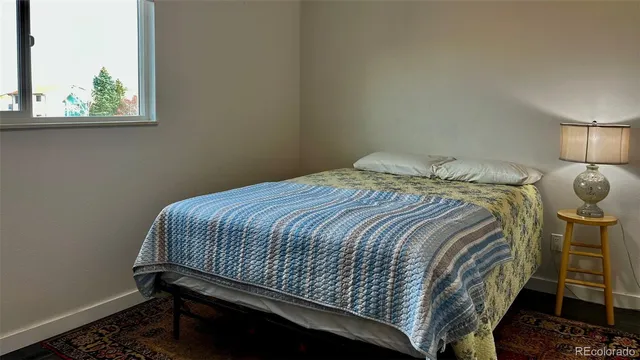 a bed sitting in a bedroom next to a window