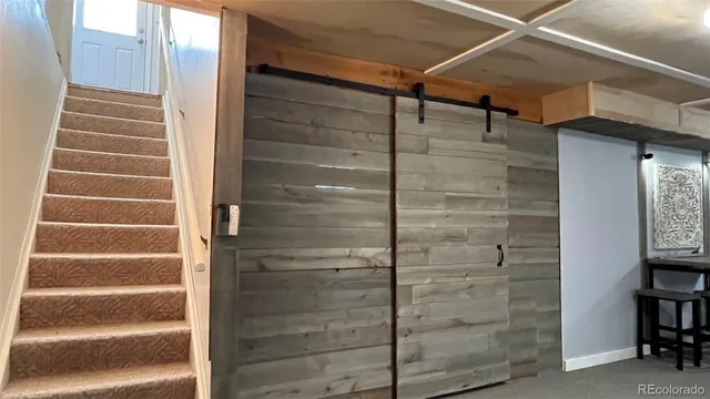 a view of a bedroom with furniture and a window