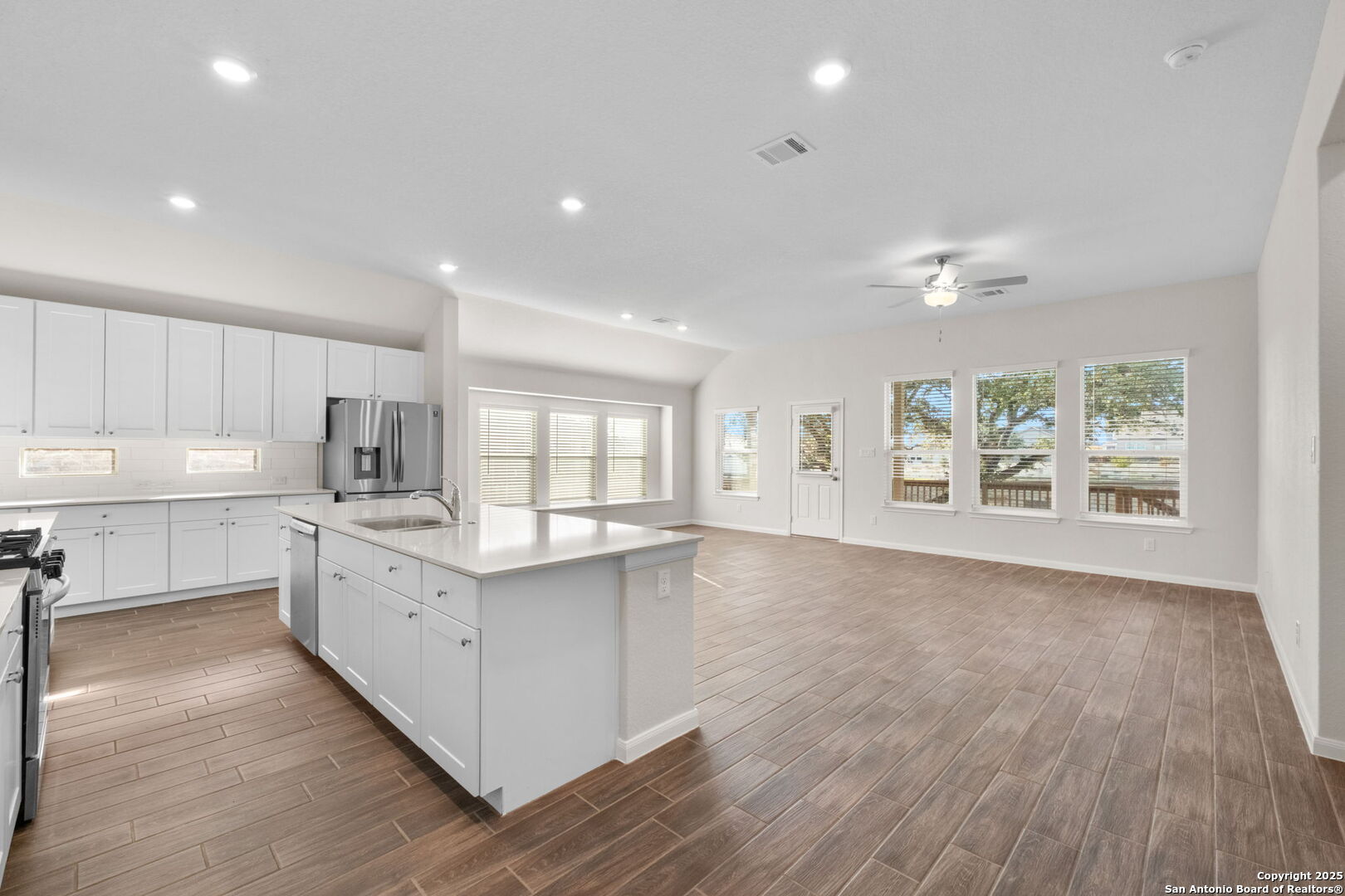 6056 Draw Loop Bulverde, TX 78163 - Photo 16 of 36 a large kitchen with stainless steel appliances a large counter top a sink and a window