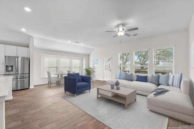 a living room with furniture and a large window