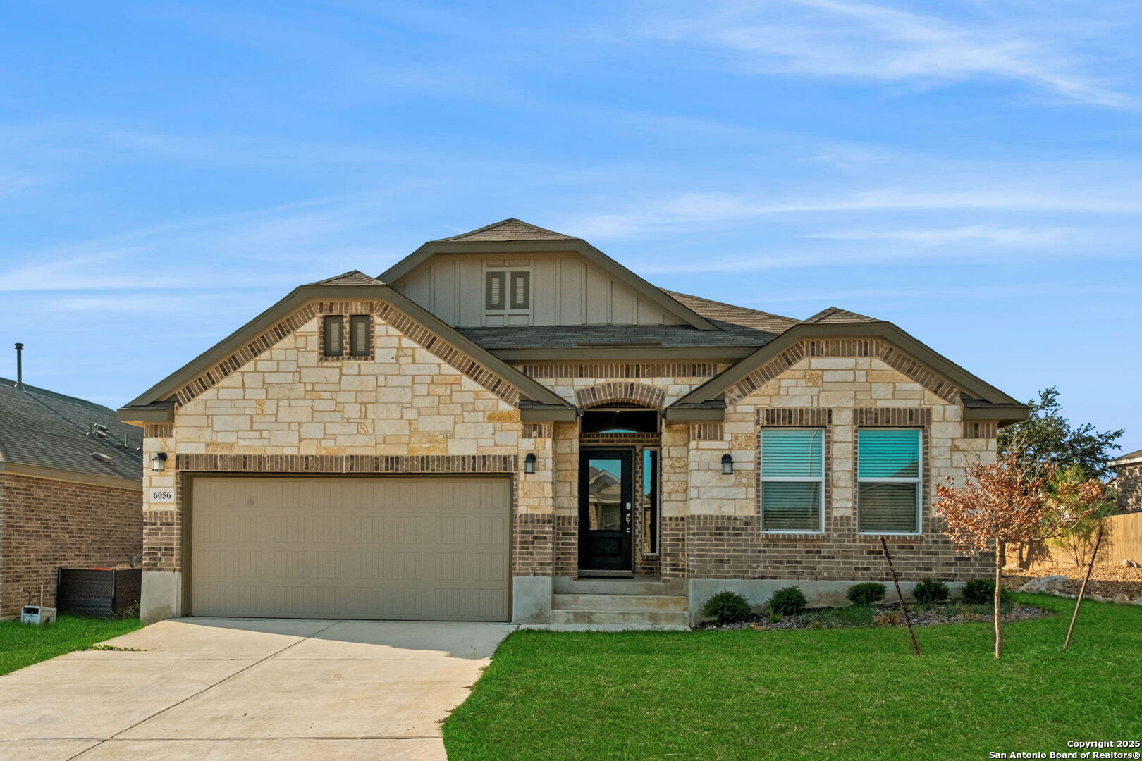 6056 Draw Loop Bulverde, TX 78163 - Photo 2 of 36 a front view of a house with a garden