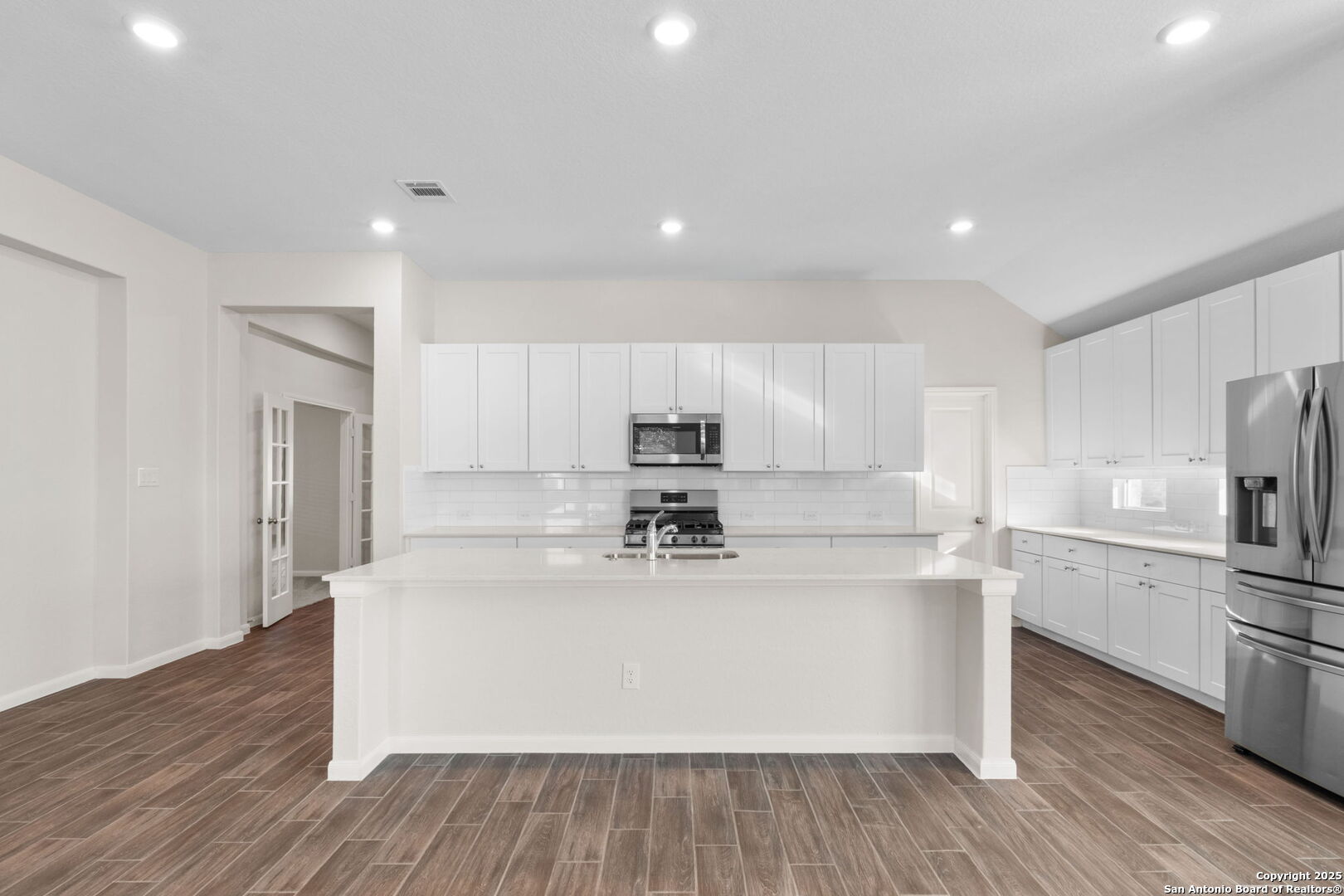 6056 Draw Loop Bulverde, TX 78163 - Photo 22 of 36 a view of kitchen with cabinets stainless steel appliances and wooden floor