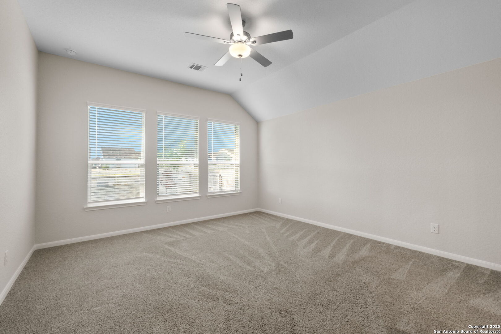 6056 Draw Loop Bulverde, TX 78163 - Photo 25 of 36 an empty room with a window and a fan