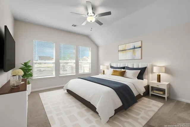 a spacious bedroom with a large bed and a chandelier