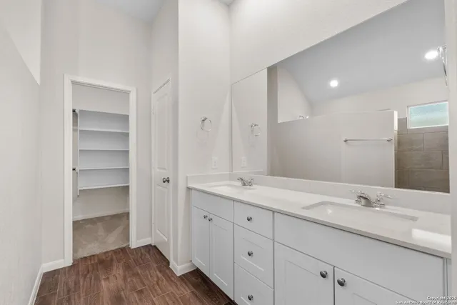 a bathroom with a sink double vanity and a mirror