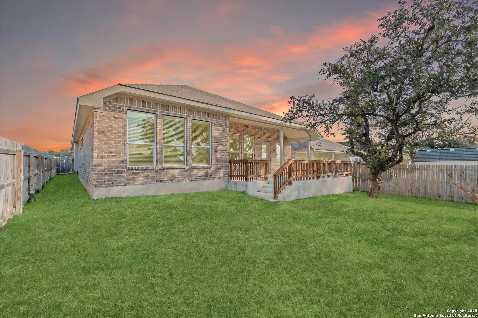 6056 Draw Loop Bulverde, TX 78163 - Photo 33 of 36 a view of a house with backyard and a garden