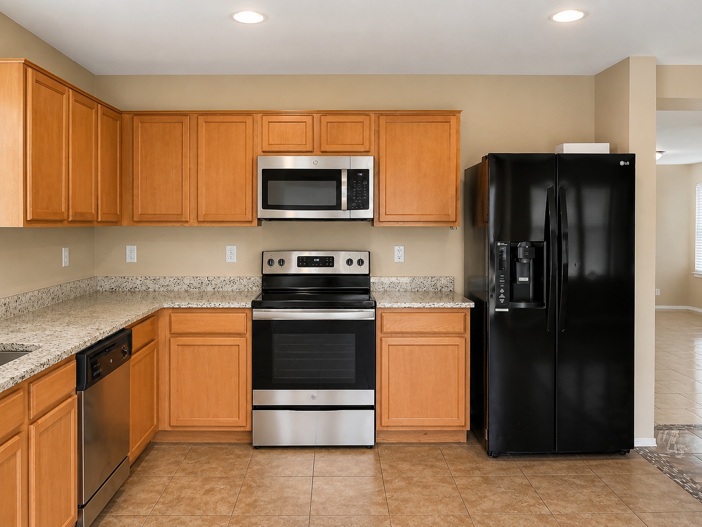 122 Rummel Drive Kyle, TX 78640 - Photo 8 of 18 An inviting kitchen features a full suite of appliances, rich wood cabinetry, and elegant granite counters.
