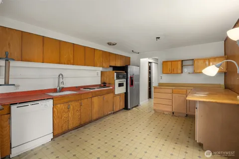 a kitchen with stainless steel appliances a sink and cabinets
