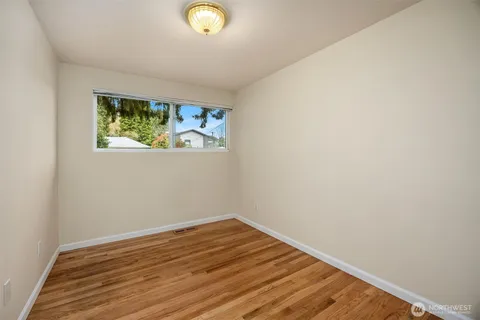 a view of room with wooden floor and window