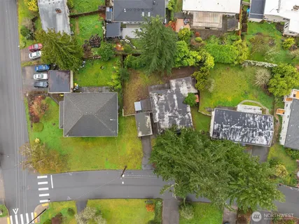 an aerial view of a house with garden space and a lake view