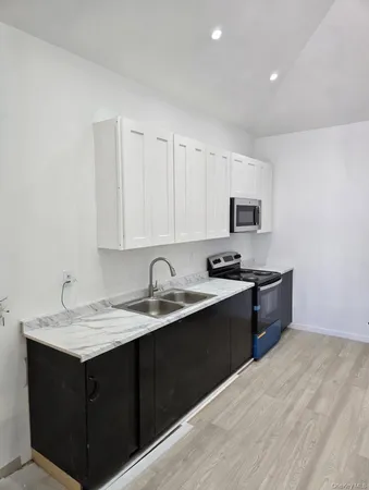 a kitchen with a sink cabinets and appliances