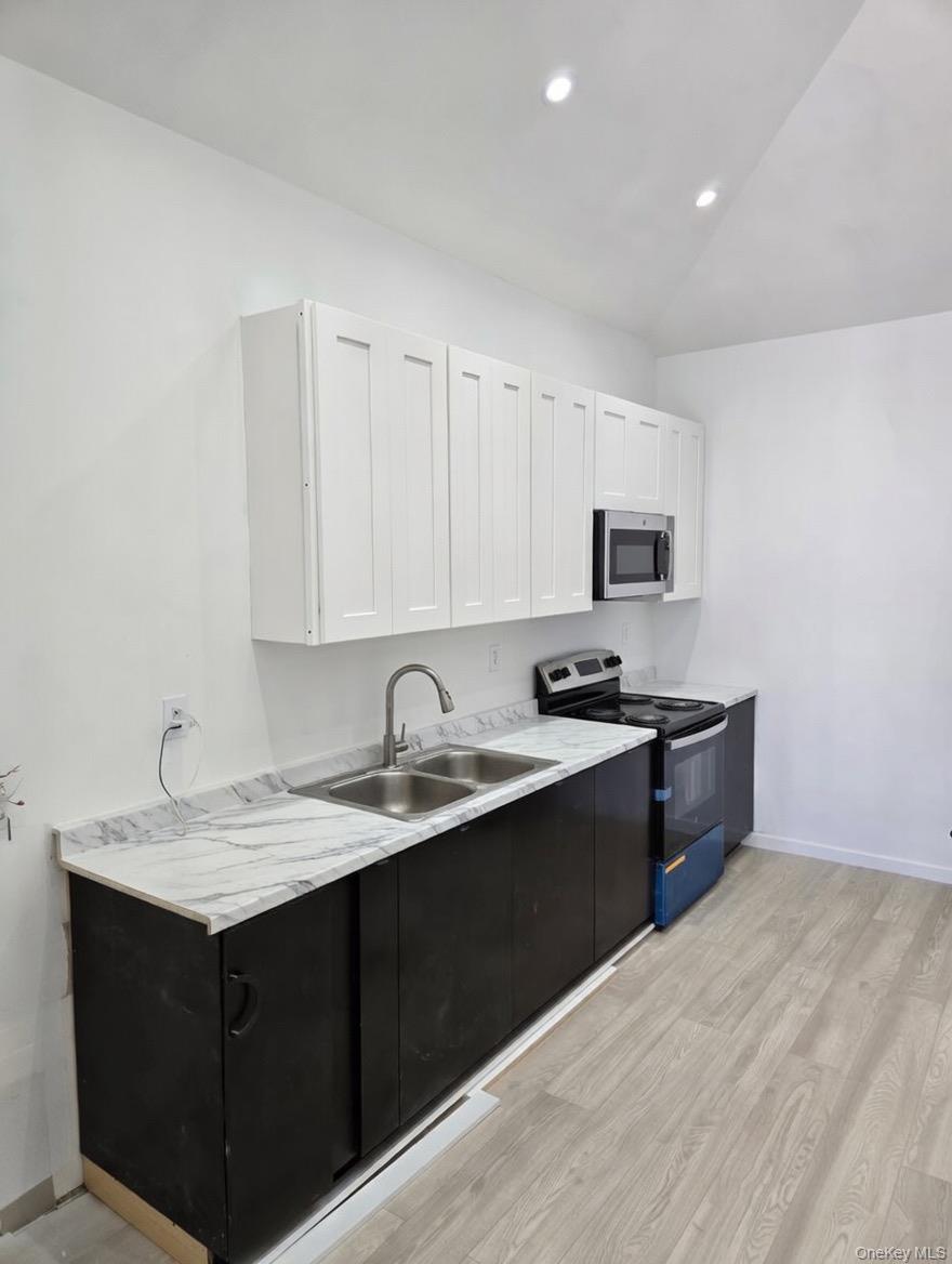 267 Morris Avenue Inwood, NY 11096 - Photo 3 of 10 a kitchen with a sink cabinets and appliances