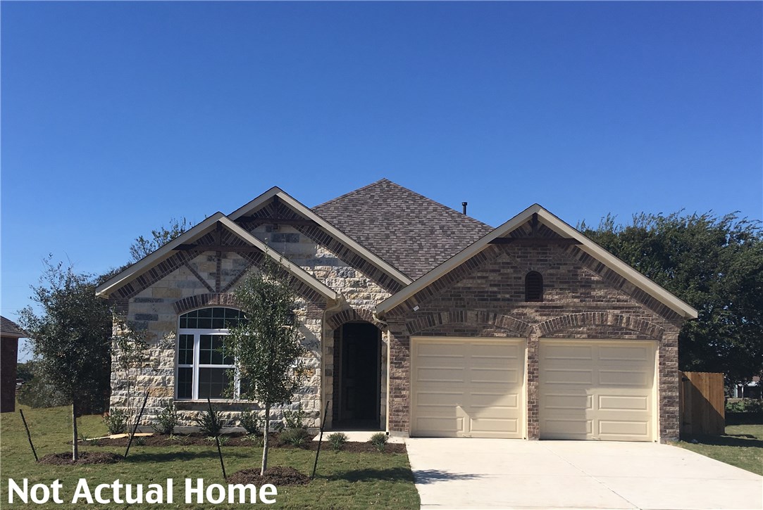1621 Highland Ridge Road Georgetown, TX 78628 - Photo 1 of 1 a front view of a house with a garden