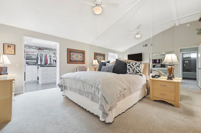 a bed room with bed and a large mirror