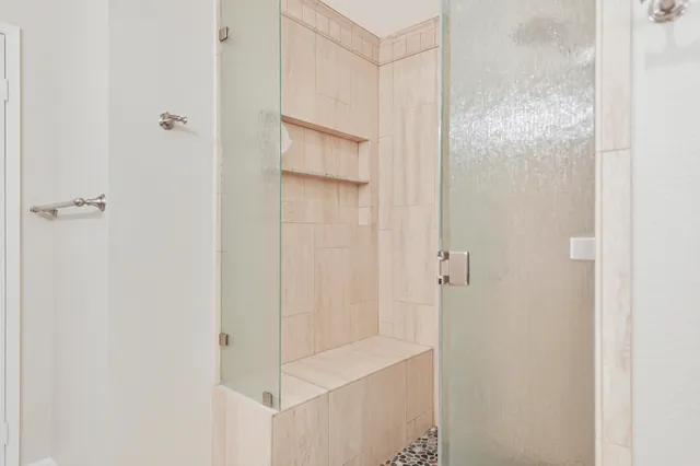 a view of walk in closet with clothes