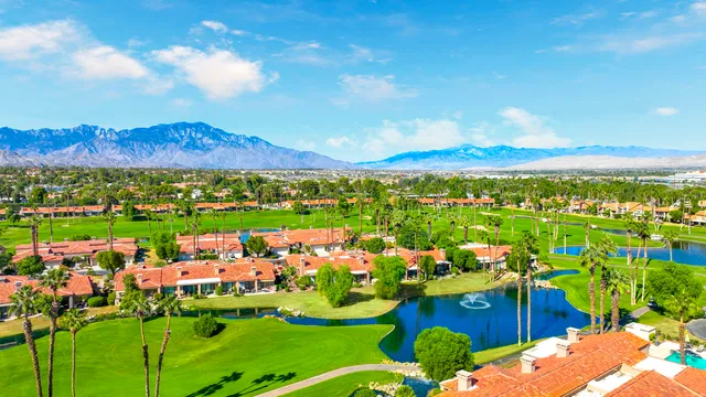 an aerial view of residential houses with outdoor space and mountain view