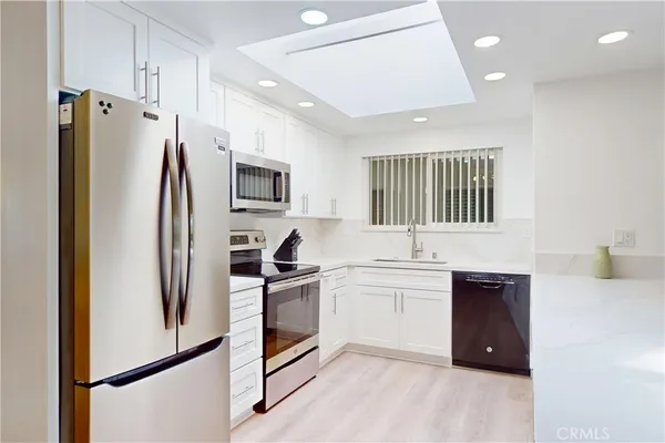 a kitchen with a sink stove and microwave