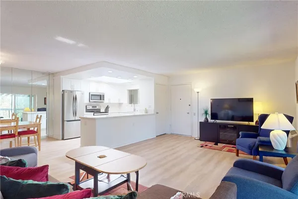 a bedroom with a bed and a dresser with chair