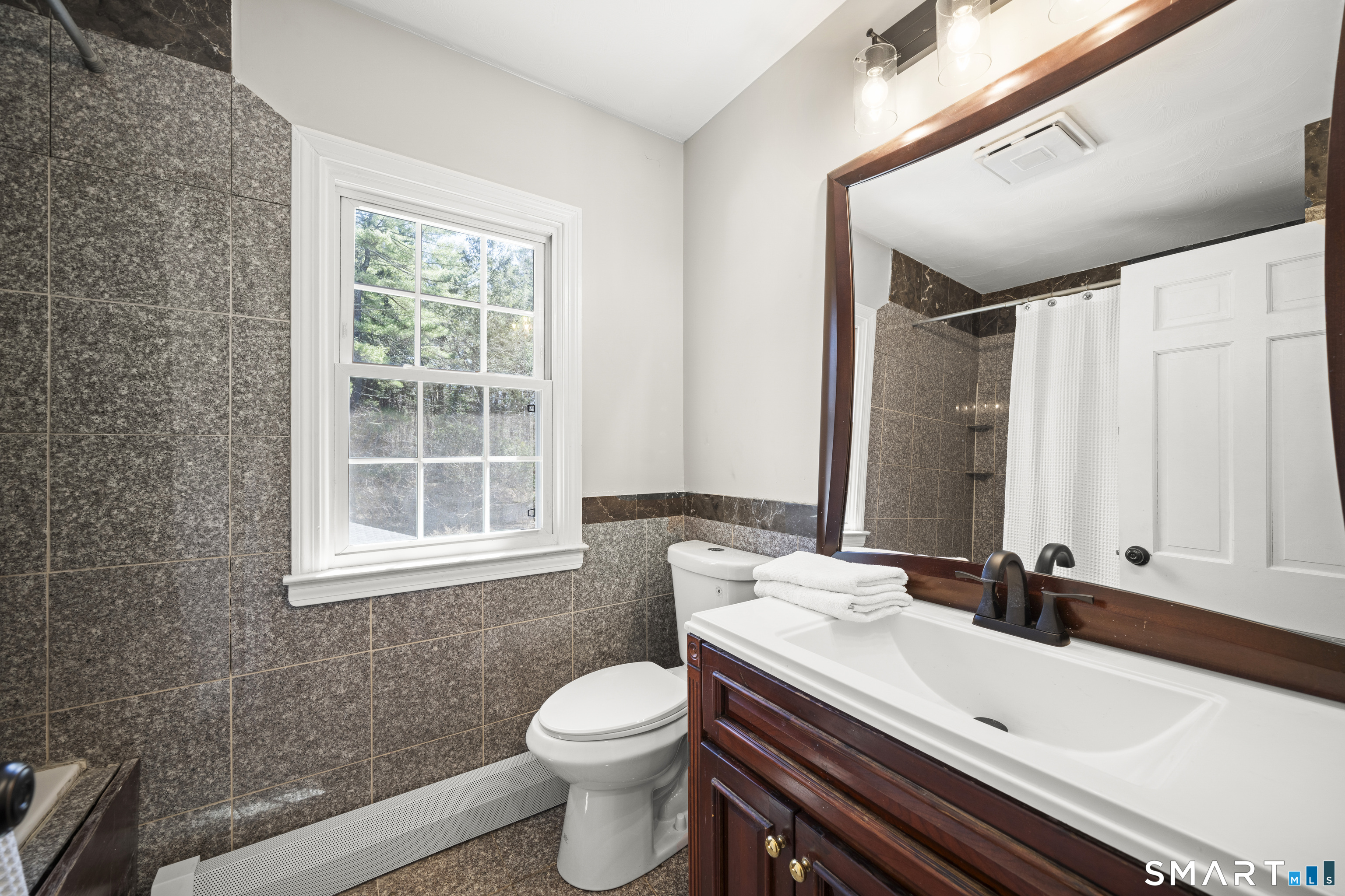 85 Lawton Road Canton, CT 06019 - Photo 32 of 38 a bathroom with a double vanity sink toilet and mirror