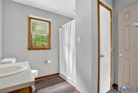 a view of a hallway with furniture and a window