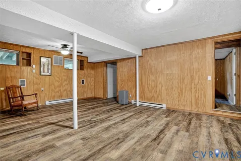 a view of a livingroom with wooden floor and a ceiling fan