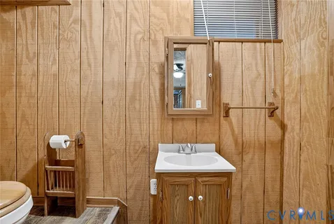 a bathroom with a sink a toilet and shower curtain